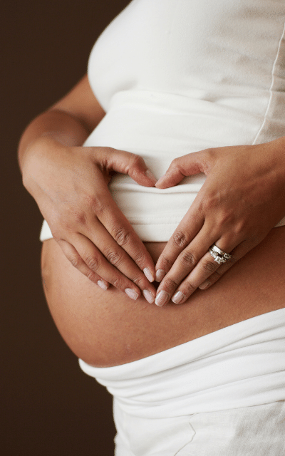 Graphic of a woman making a love heart on her pregnant belly